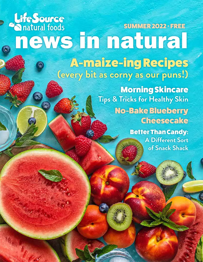 LifeSource logo | News In Natural | Image of a cascade of watermelon, strawberries, kiwis, peaches, and nectarines against a bright aquamarine blue painted rustic background