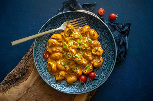 Chorizo Mac & Cheese in a ceramic bowl, with a fork
